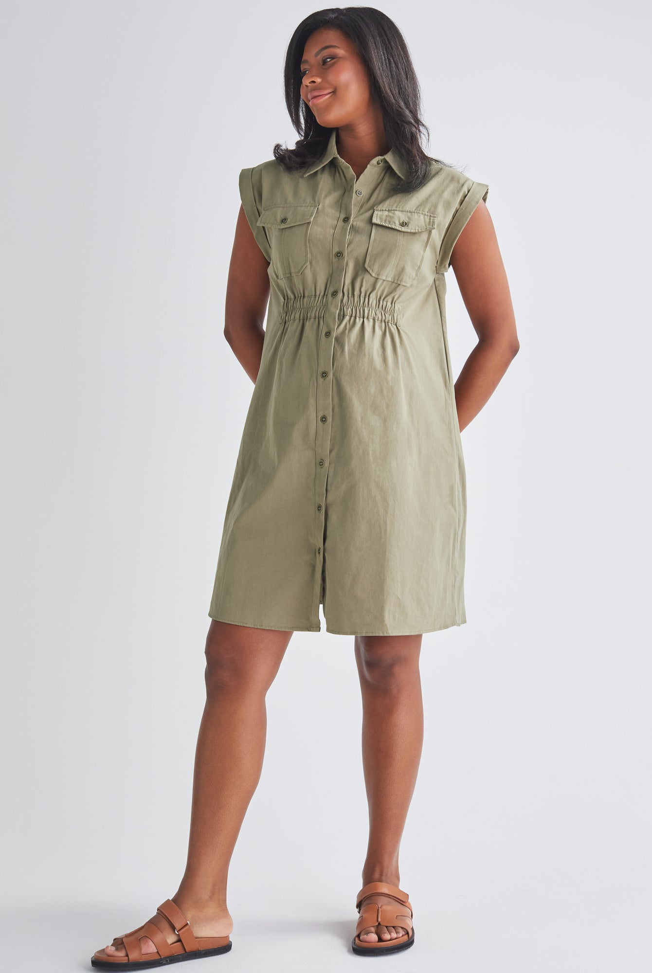 A Pregnannt Woman Wearing Kaya Maternity Safari Shirt Cotton Dress In Khaki from Angel Maternity.