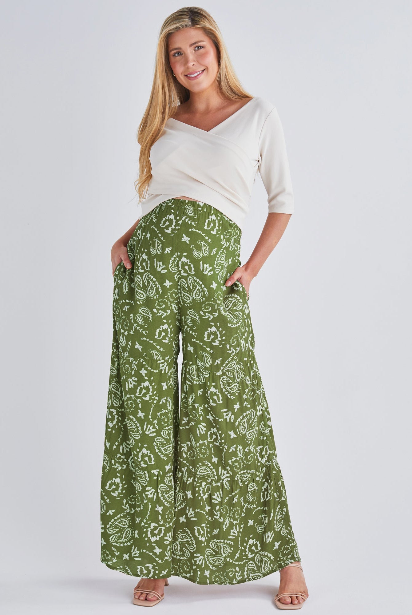A pregnant Woman Wearing Stacie Wide Leg Green Maternity Pants in Paisley Print from Angel Maternity
