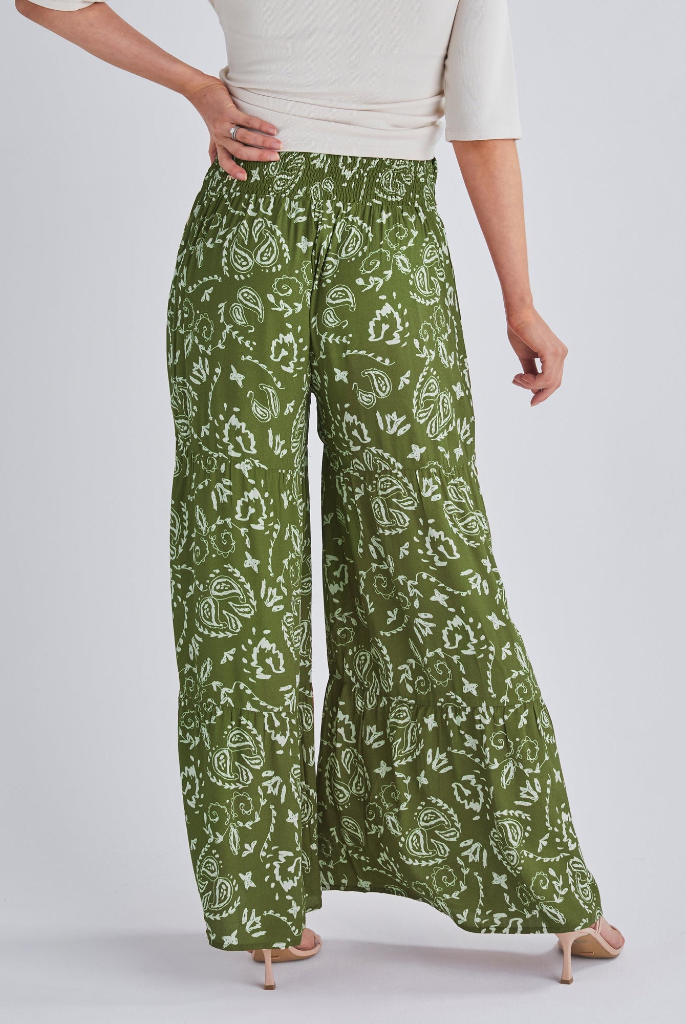 Back View - A pregnant Woman Wearing Stacie Wide Leg Green Maternity Pants in Paisley Print from Angel Maternity