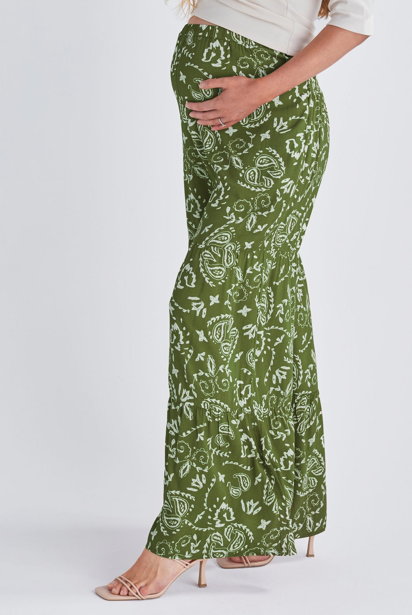 Side View - A pregnant Woman Wearing Stacie Wide Leg Green Maternity Pants in Paisley Print from Angel Maternity