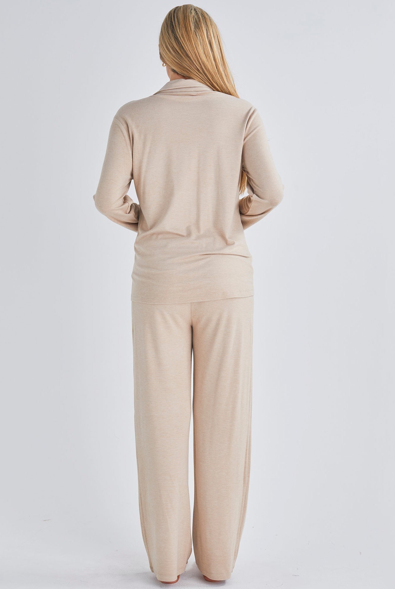 Back view - A pregnant woman wearing button front nursing freindly pyjama set in pink from Angel Maternity.