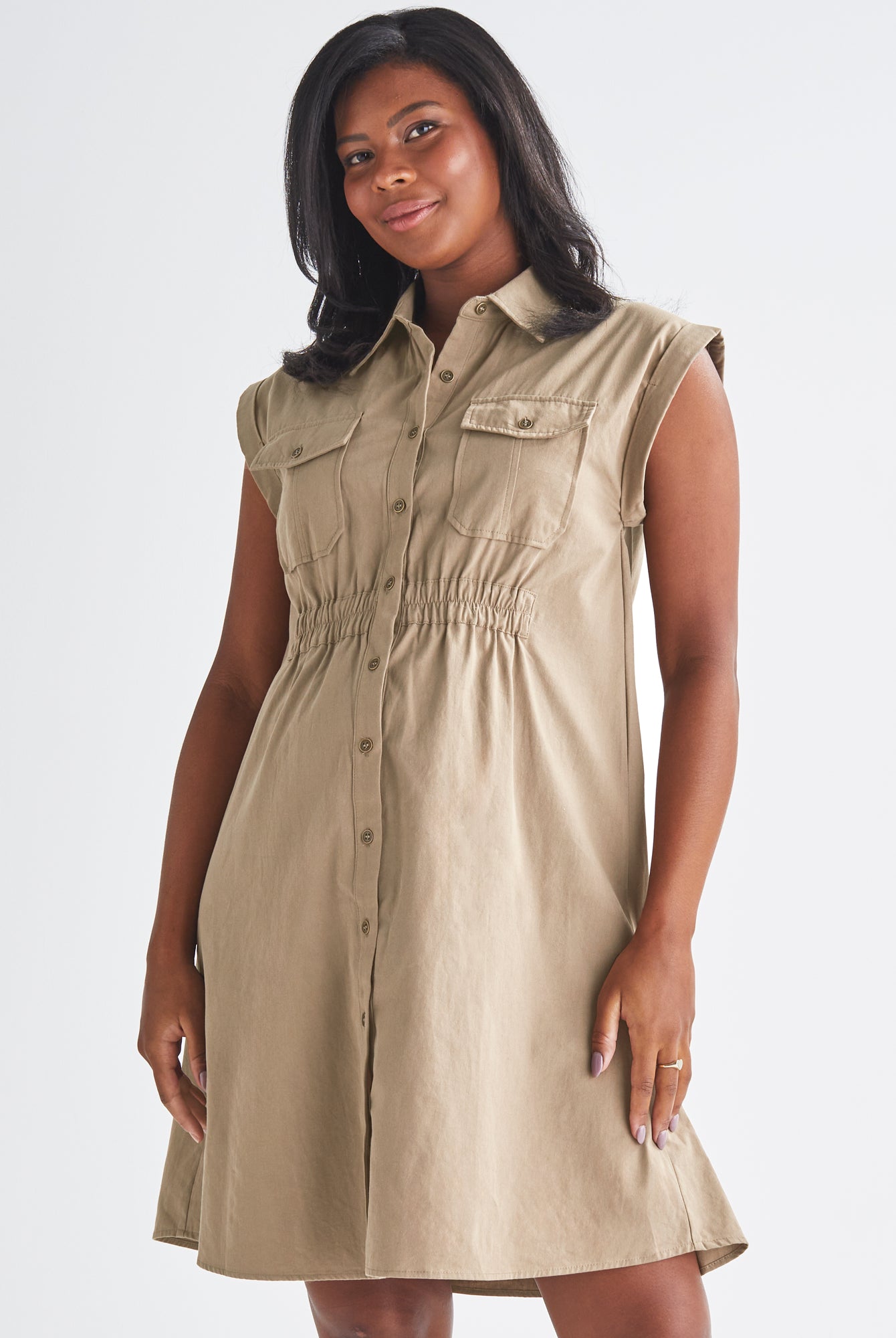 A Pregnannt Woman Wearing Kaya Maternity Safari Cotton Shirt Dress In Beige from Angel Maternity.