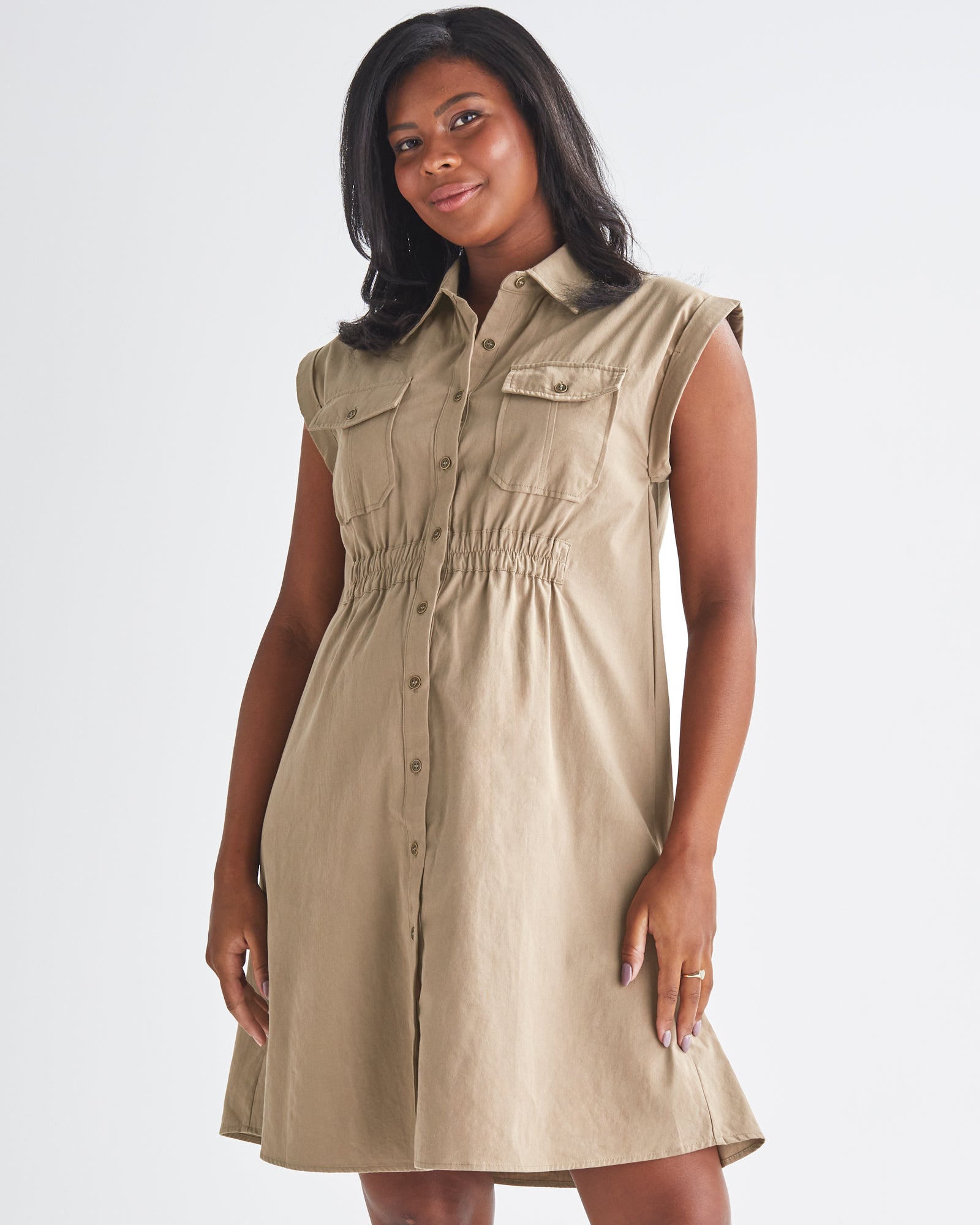 A Pregnannt Woman Wearing Kaya Maternity Safari Cotton Shirt Dress In Beige from Angel Maternity.