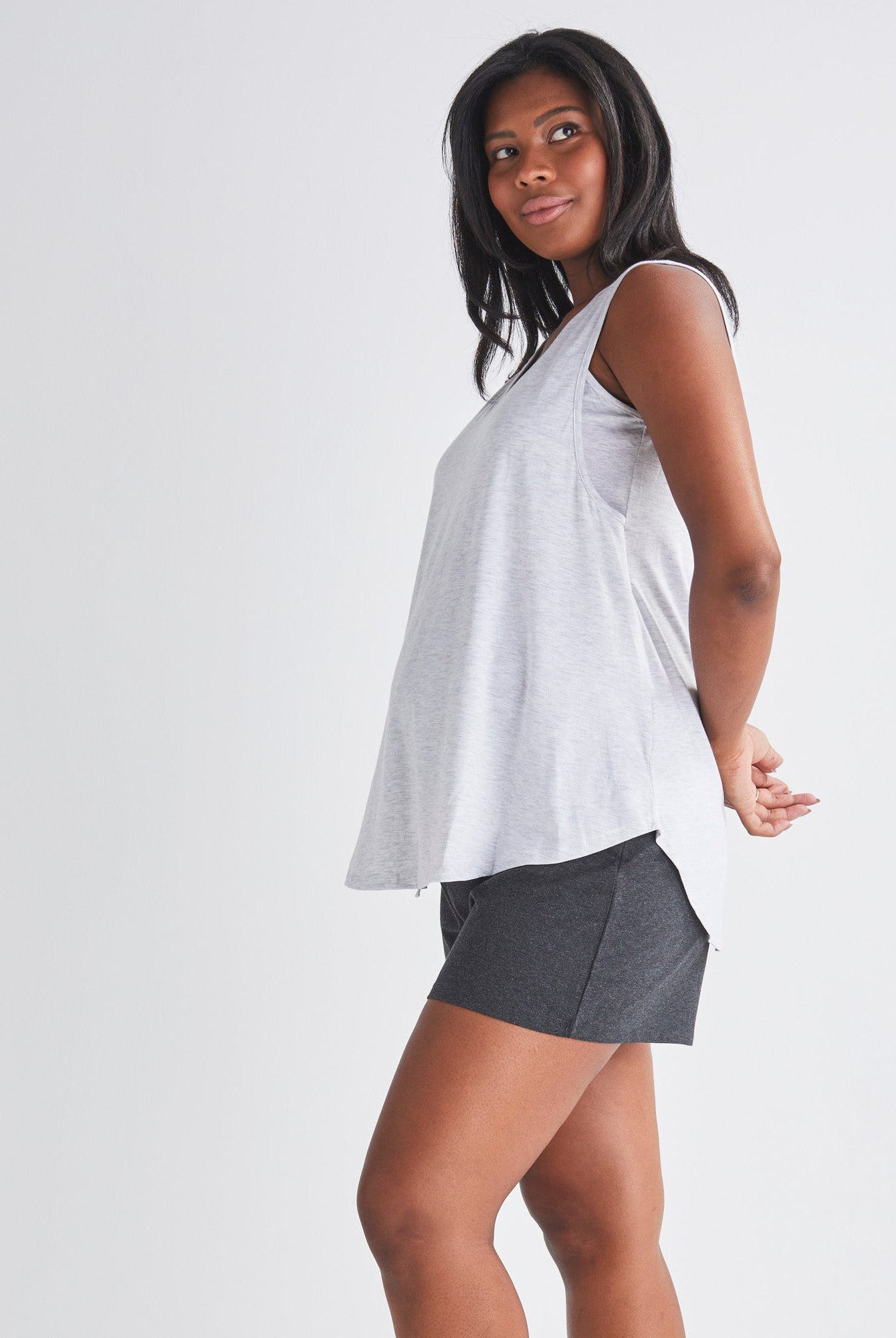 Side View - A Pregnannt Woman Wearing 2-piece Maternity/Nursing Pyjama Set - Top & Shorts from Angel Maternity.