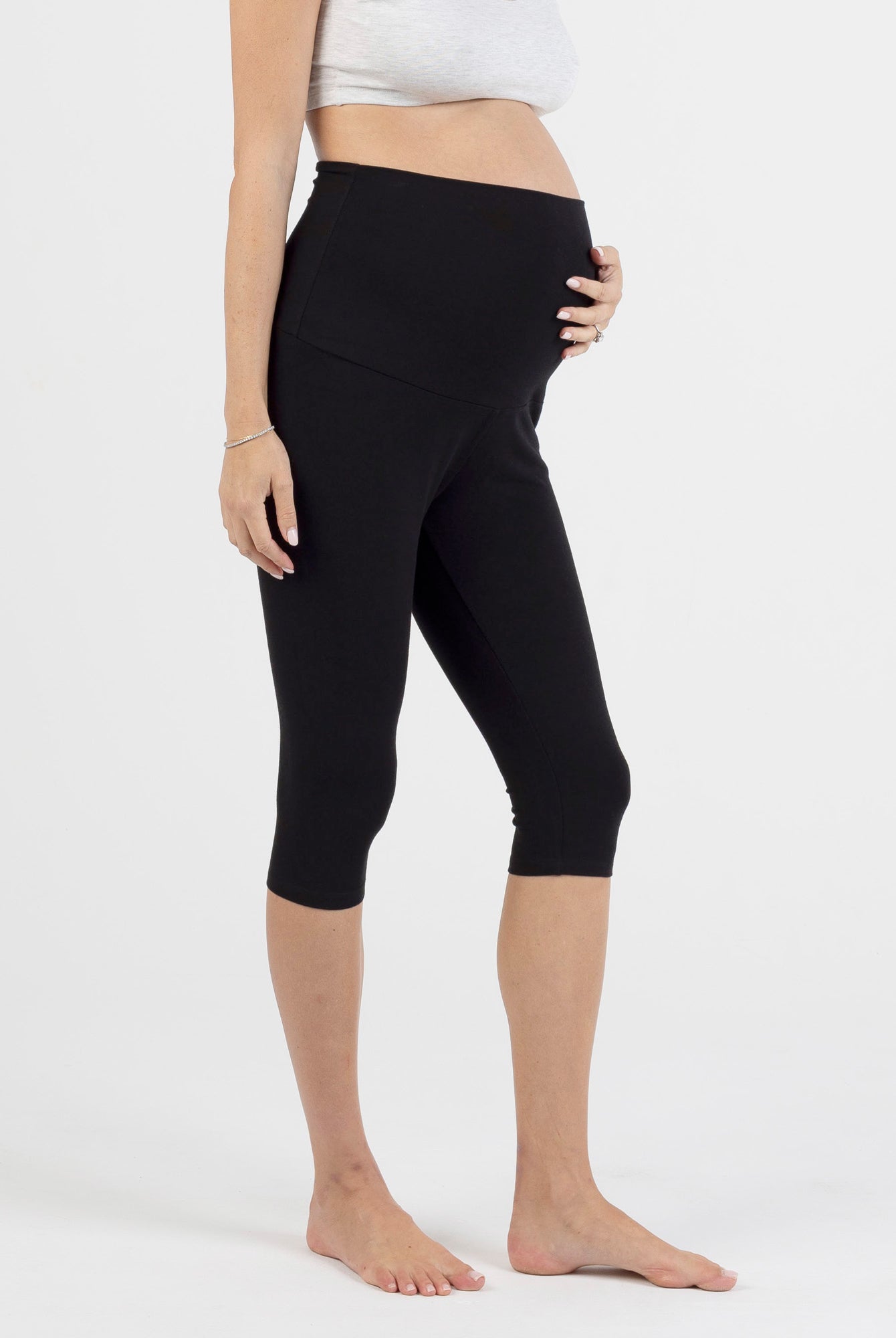 pregnant women wearing black capri maternity leggings