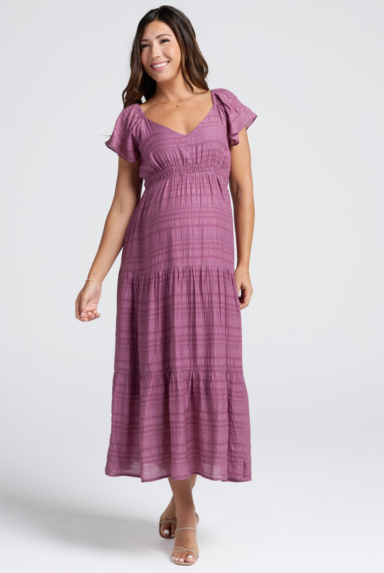 Woman wearing a purple dress on a white background