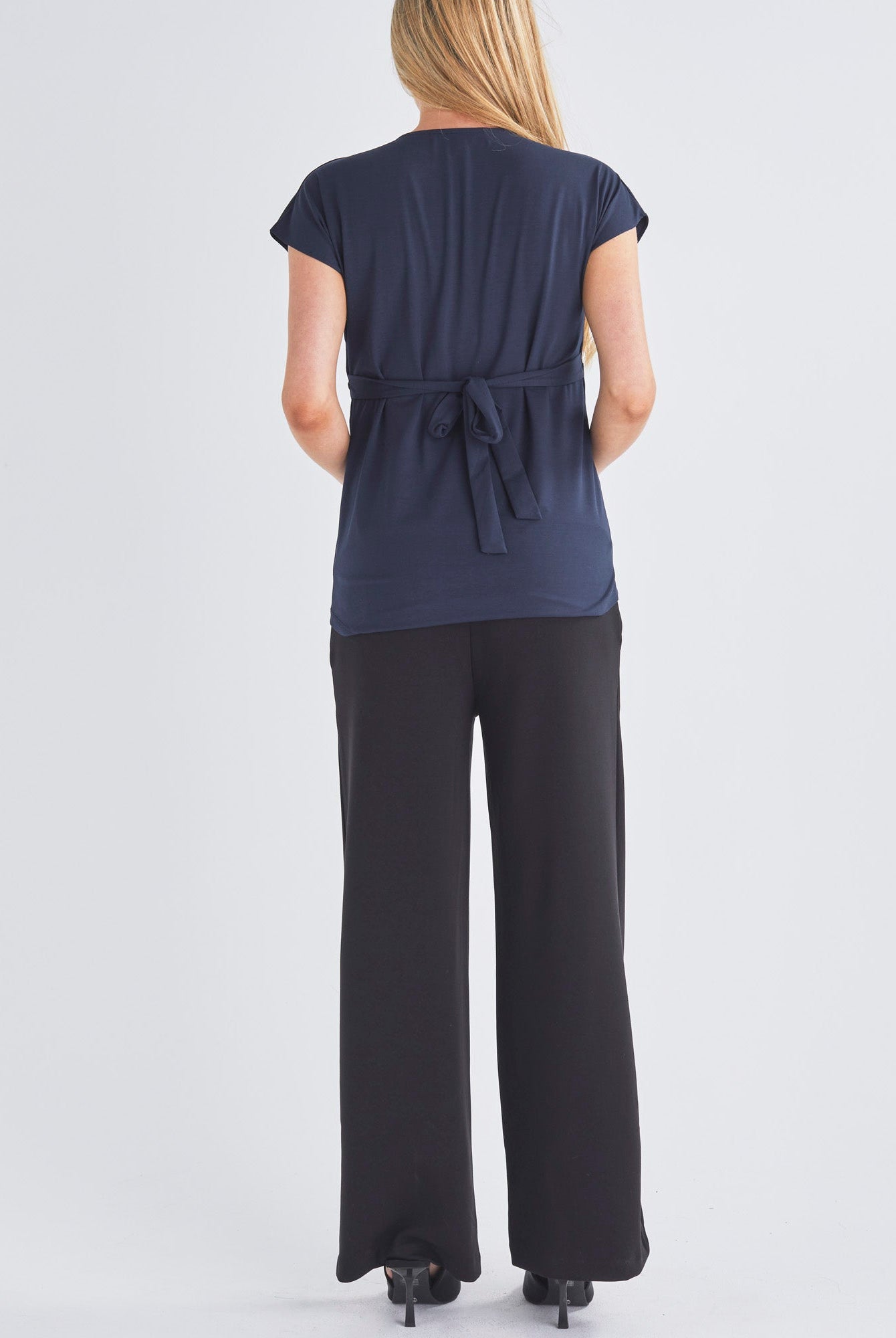 Back View - A Pregnant Woment Wearing Elodie Wide Leg Maternity Black Work Pant in Ponti from Angel Maternity Australia