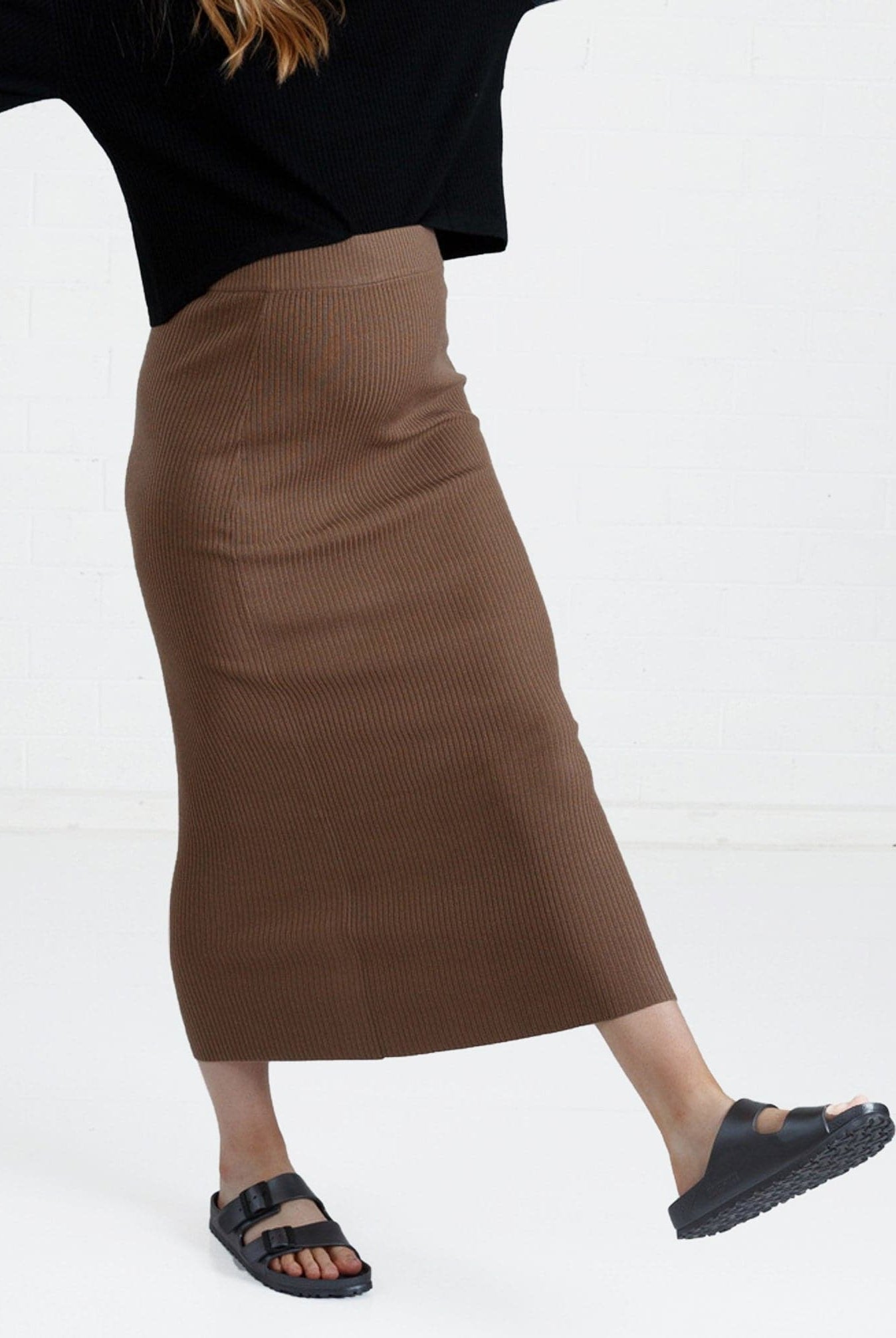 a woman in brown maternity angel maternity wool blend knit skirt with side split, front (6651643461735)