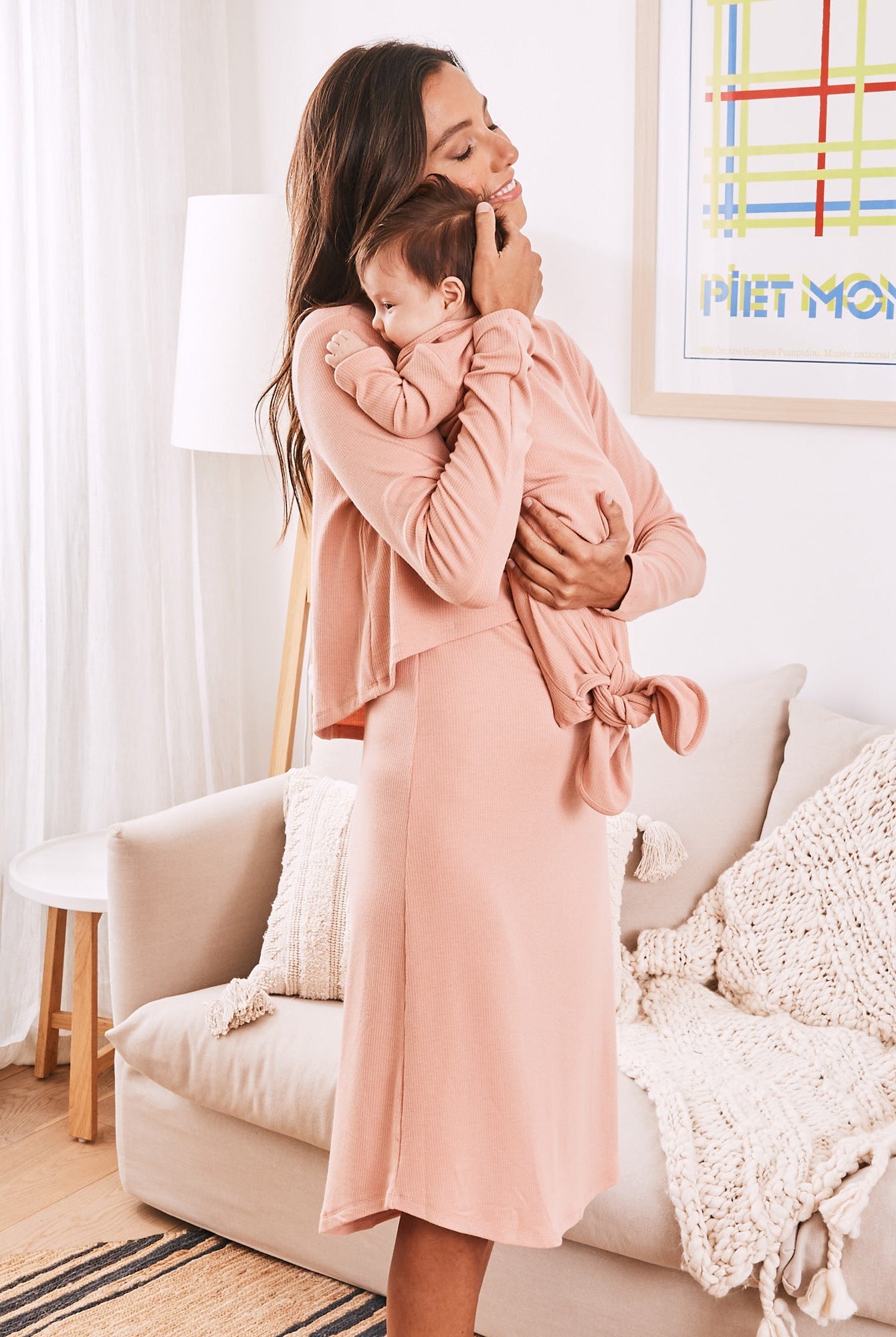 A women nursing a baby- wearing maternity nursing friendly loungewear dress in pink