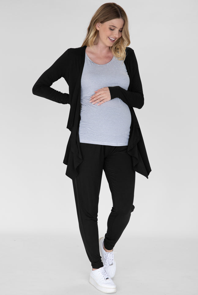 A smiling pregnant woman in -piece relax set standing (4826976813150)