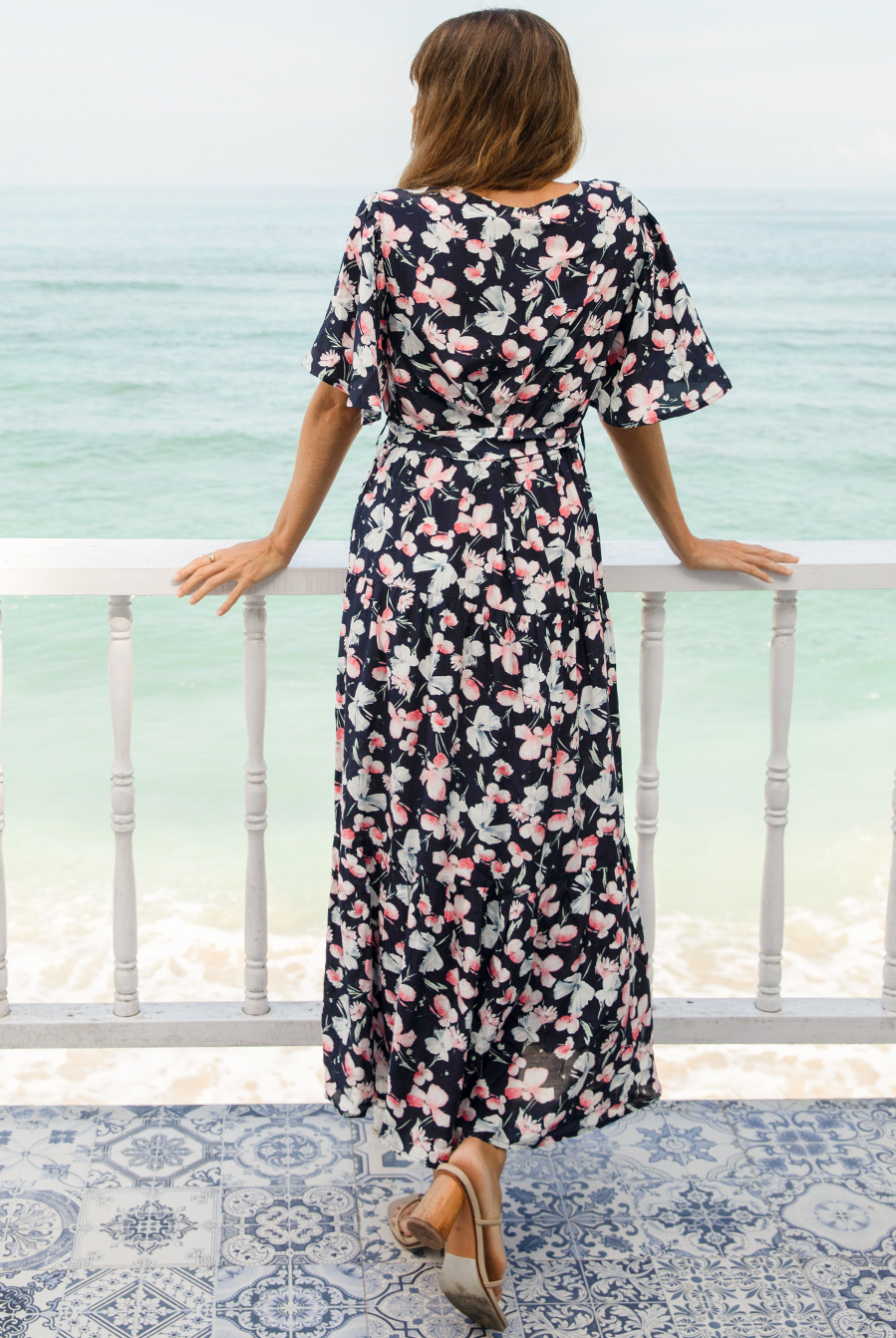 A woman in baby shower navy floral print maternity dress, back (6659011674206)