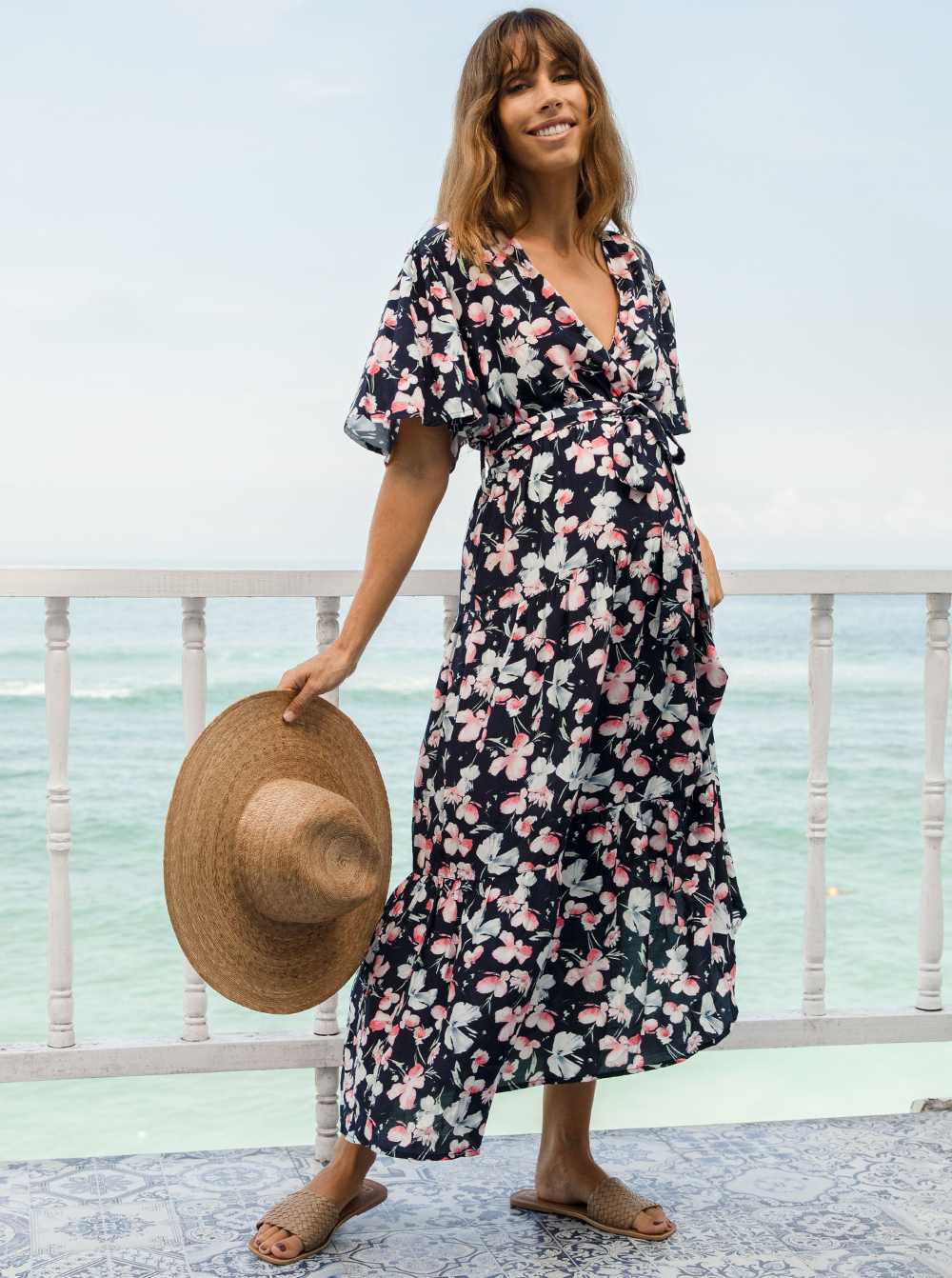 A woman in baby shower navy floral print maternity dress, front (6659011674206)