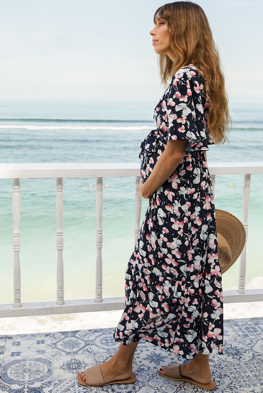 A woman in baby shower navy floral print maternity dress, side (6659011674206)