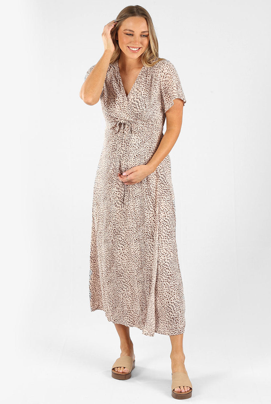 Full view - A woman in beige leopard print maternity nursing wrap dress, (6659012821086)