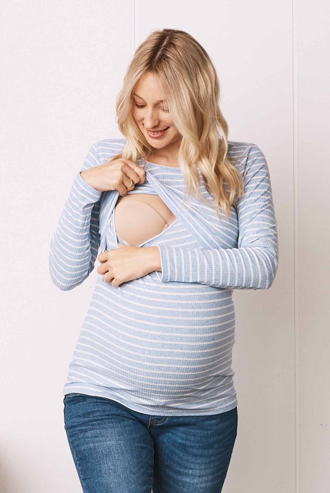 A Pregnant Woman in Long Sleeve Maternity & Nursing Cotton Top in Blue stipe Color showing breastfeeding access (6724307877982)
