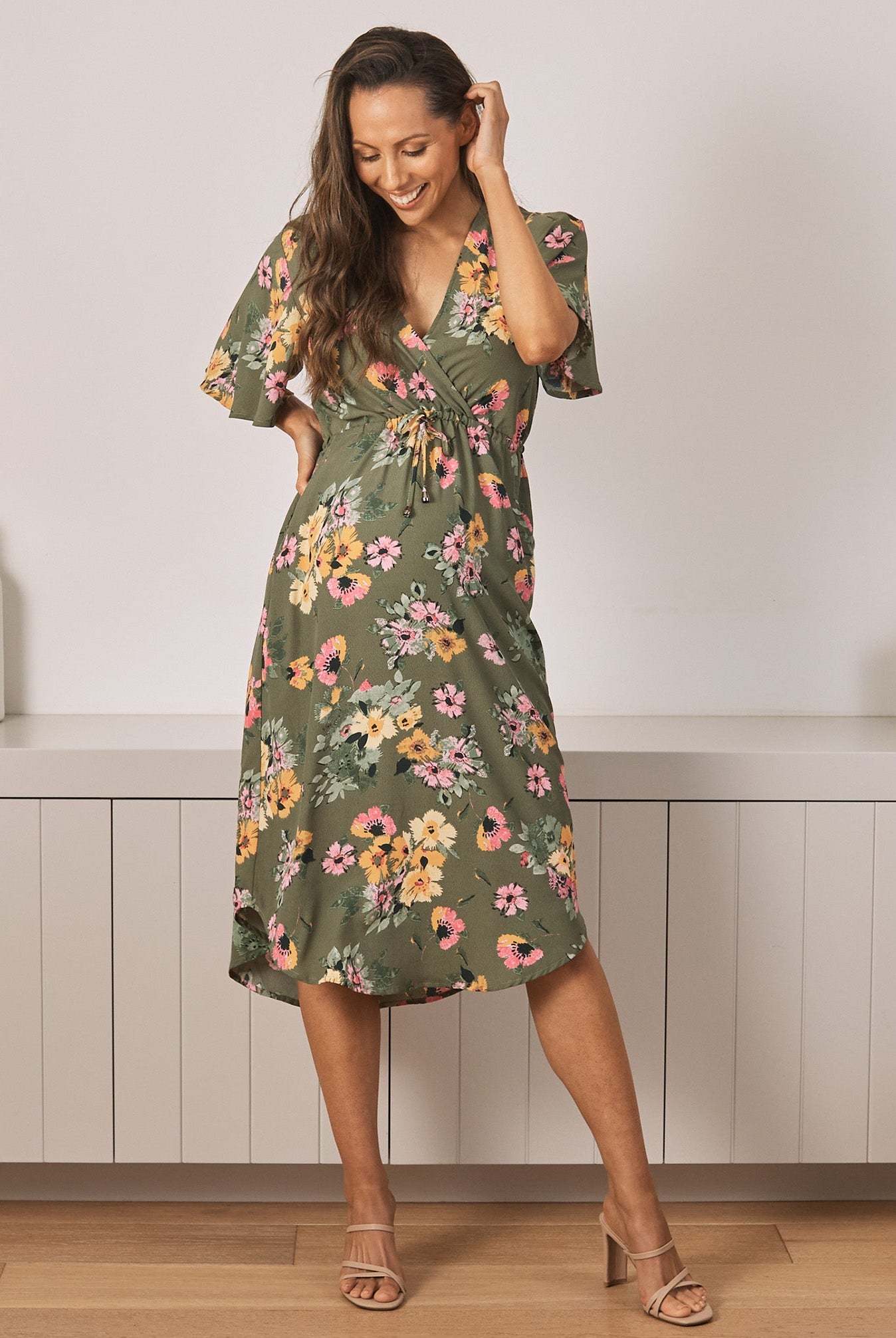 Front View - A Young Pregnant Woman in Floral Maternity Dress in Yellow Flora in Green Colour