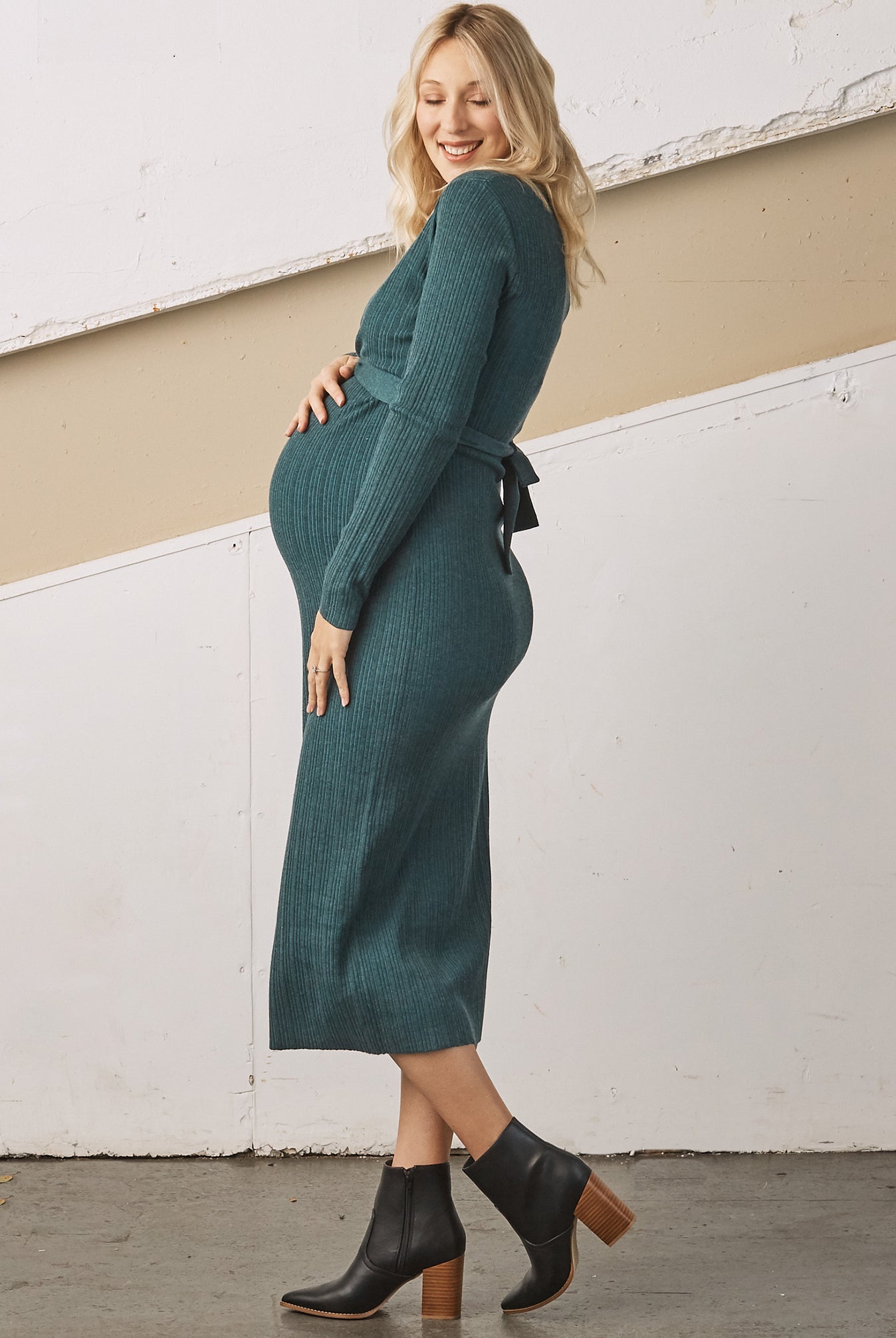 Side view - A Pregnant Woman i Annabella Knit Teal Maternity Bodycon Midi Dress touching her bump & smiling (6726615924830)