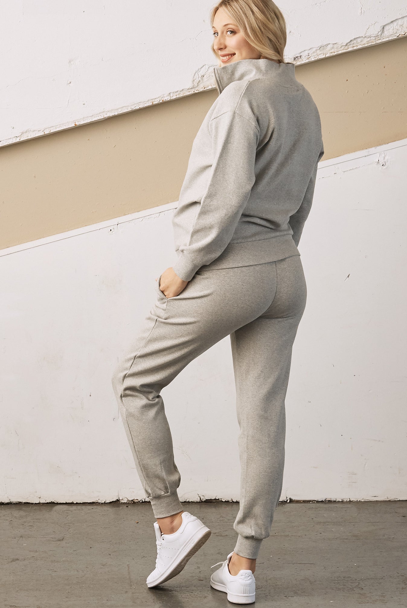 Side view - A pregnant woman in 2-Piece Calla zip front grey Maternity Tracksuit Set (6726621003870)