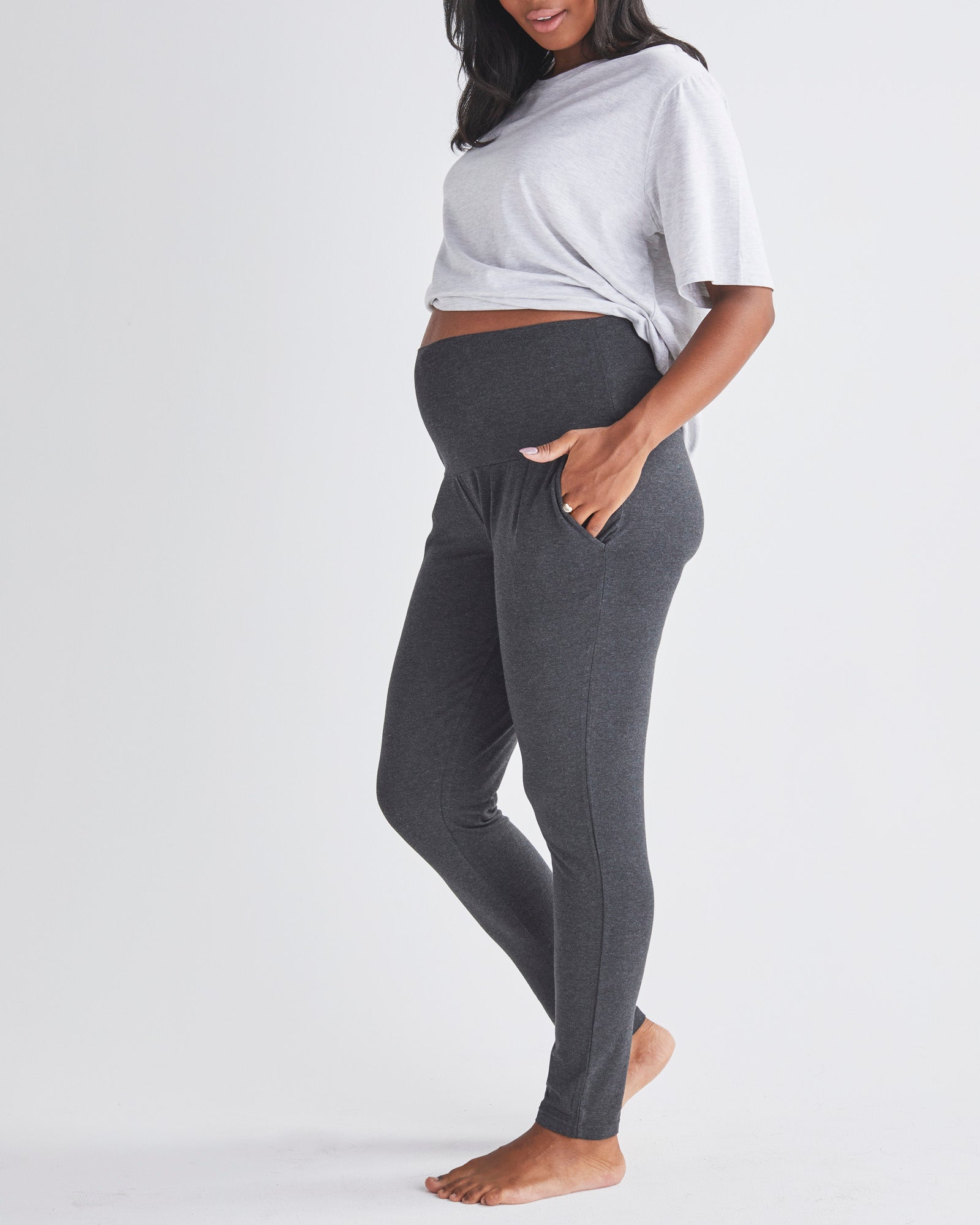 side View - A Pregnannt Woman Wearing Eden Ultra Soft Maternity Lounge Pants in Charcoal from Angel Maternity.