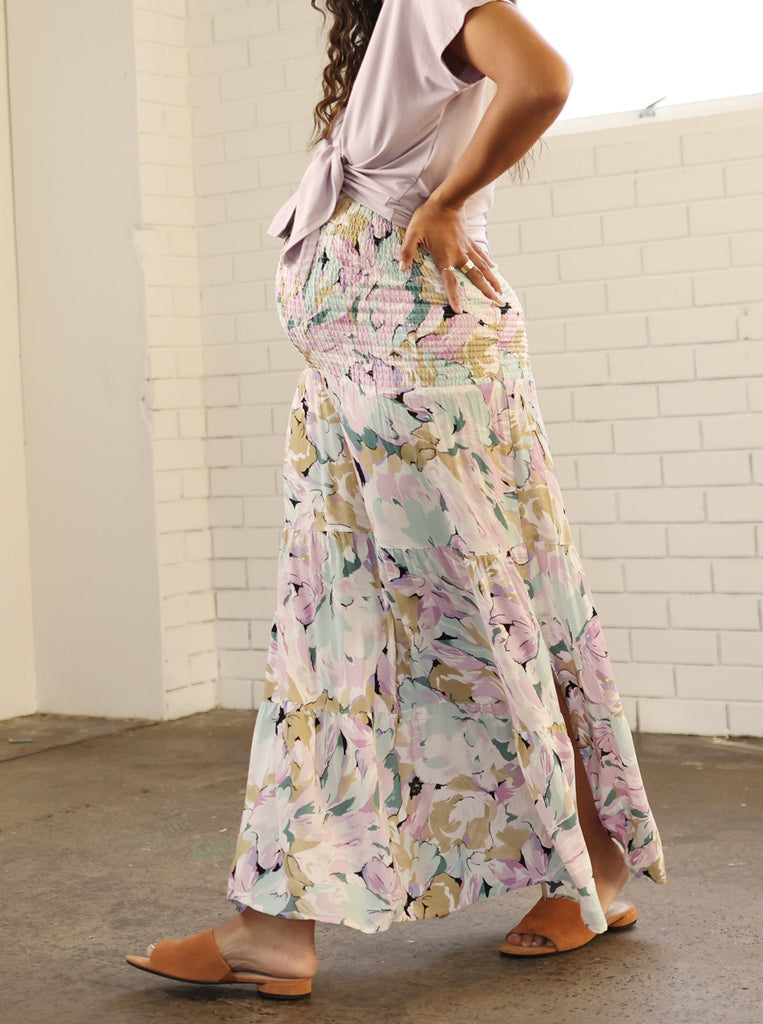 Main view - A Pregnant Woman in Ellie Maternity Shirred Maxi Skirt in Purple Floral Print (6712925978727)
