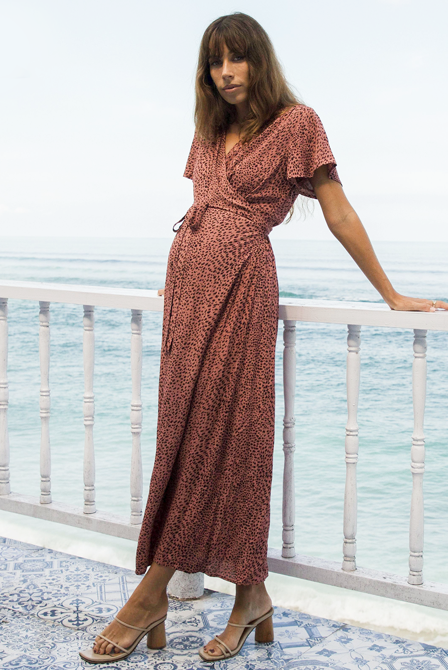 Front view - A pregnant woman in Rust Leopard Print Maternity & Nursing Maxi Dress standing on a balcony near beach (6648841961566)