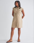Full View - A Pregnannt Woman Wearing Kaya Maternity Safari Cotton Shirt Dress In Beige from Angel Maternity.