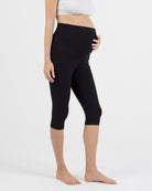 pregnant women wearing black capri maternity leggings 
