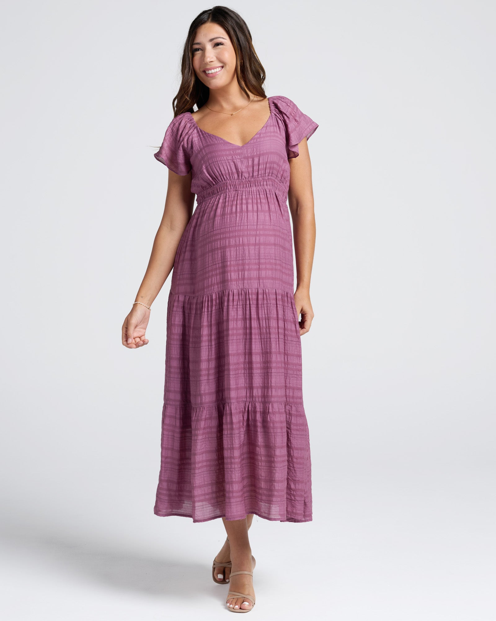 Woman wearing a purple dress on a white background