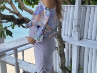 A woman in fitted mauve maternity skirt, video