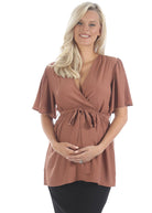 Main View - A Pregnant Woman in Flare Sleeve Maternity Top in Rust Color for Casual or Work from Angel Maternity (6680497094750)