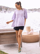 Full View - A Young Pregnant Woman in Summer Low Waist Maternity Linen Shorts in Navy Blue Colour