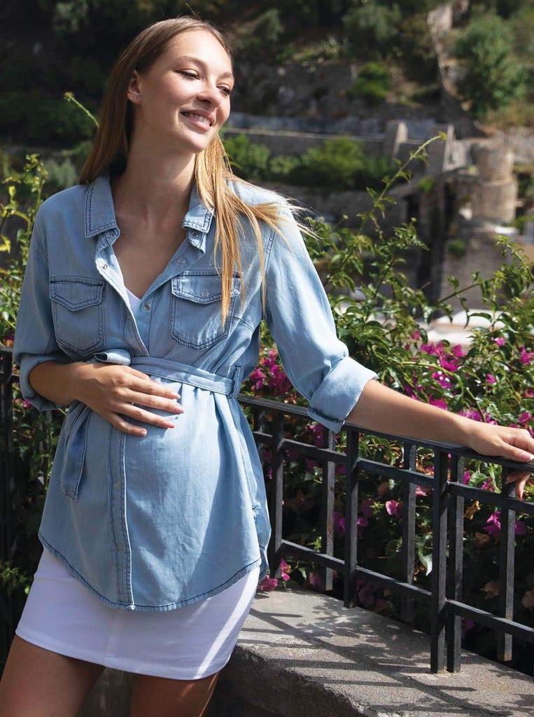 Main view - A pregnant woman in Maternity Blue Denim Shirt smiling (6621384278110)
