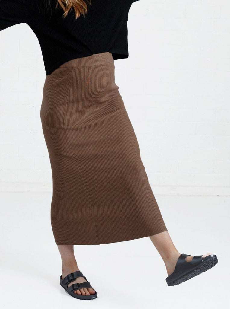a woman in brown maternity angel maternity wool blend knit skirt with side split, front (6651643461735)