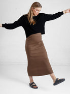 a woman in brown maternity angel maternity wool blend knit skirt with side split, full looks (6651643461735)