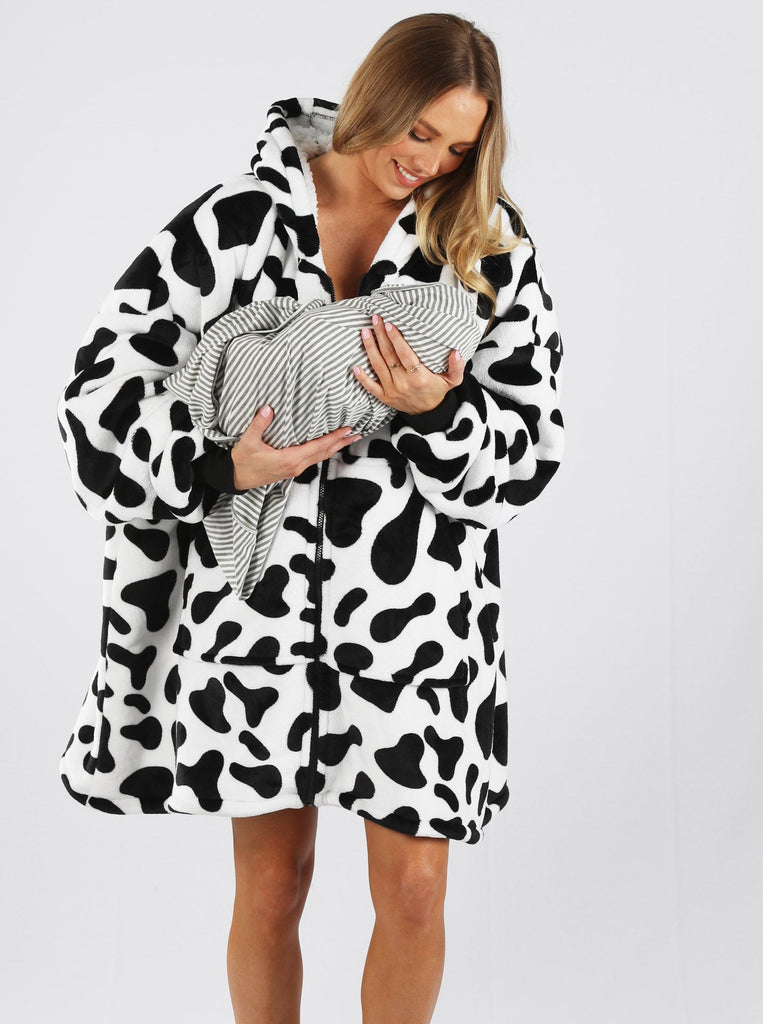 Main view - A pregnant woman in cow print front zip maternity & nursing blanket hoodie  holding baby & smiling (6724236804190)