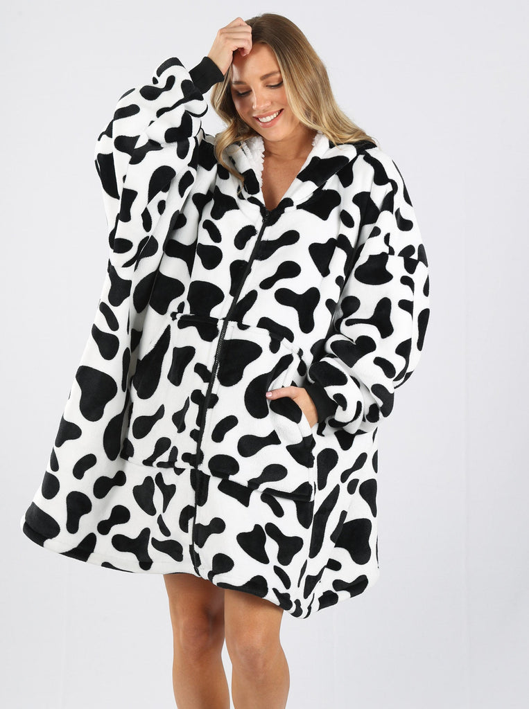 Front view - A pregnant woman in cow print front zip maternity & nursing blanket hoodie one hand in pocket smiling (6724236804190)