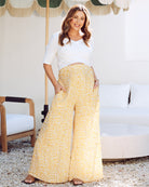 Front view - maternity wide leg pants in mustard print