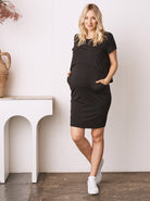 a pregnant women in black maternity dress from Angel Maternity