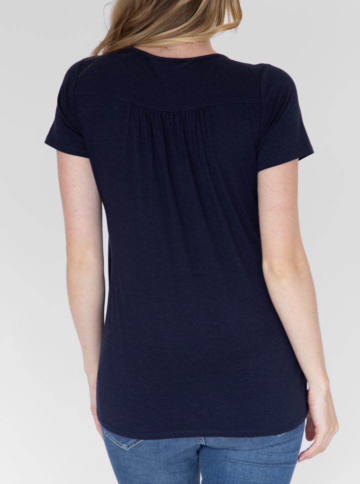 Back view - A woman in petal front short sleeve nursing top in navy (4828435513438)