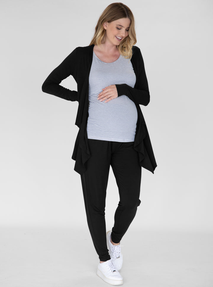A smiling pregnant woman in -piece relax set standing (4826976813150)
