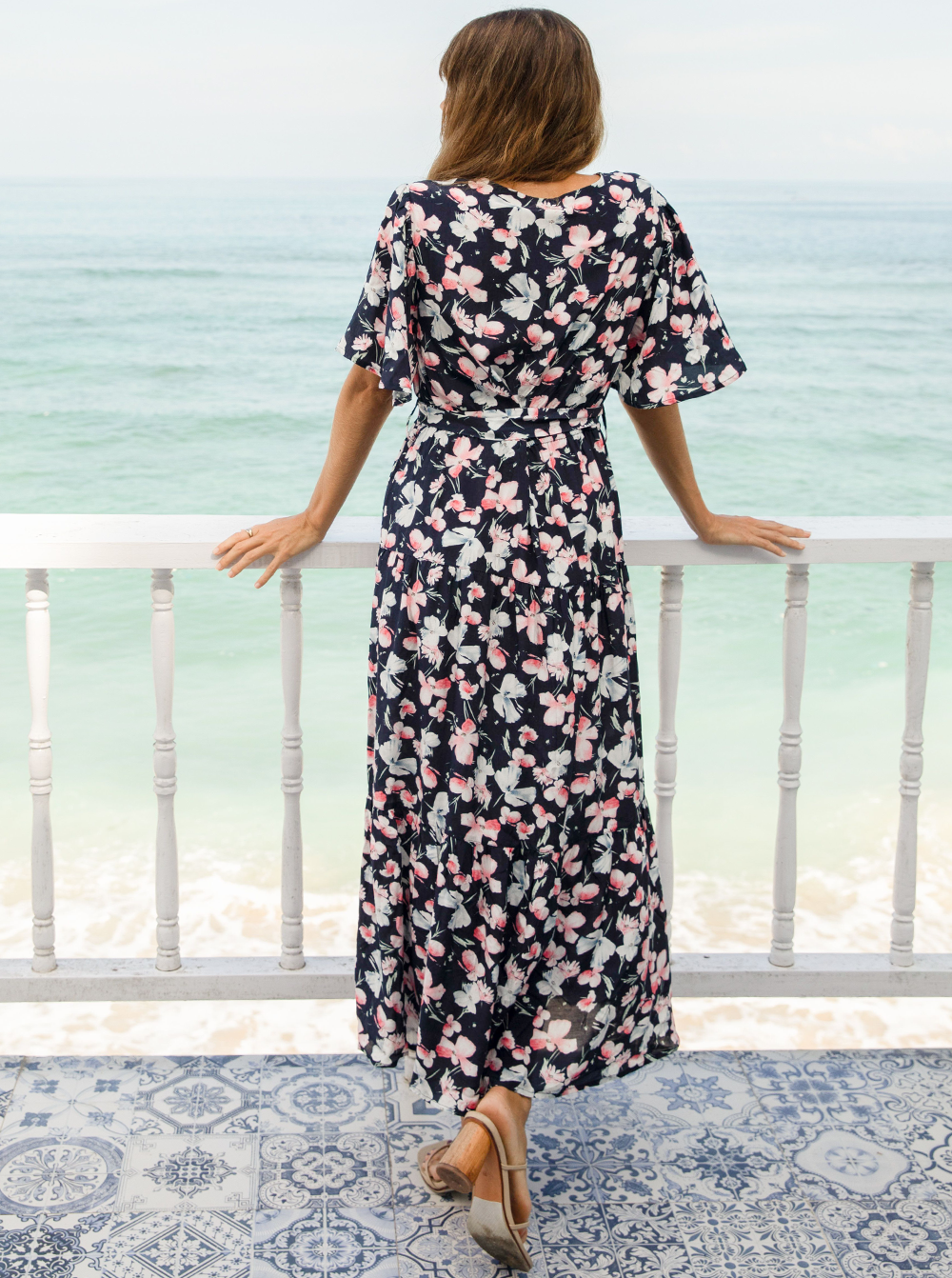 A woman in baby shower navy floral print maternity dress, back (6659011674206)