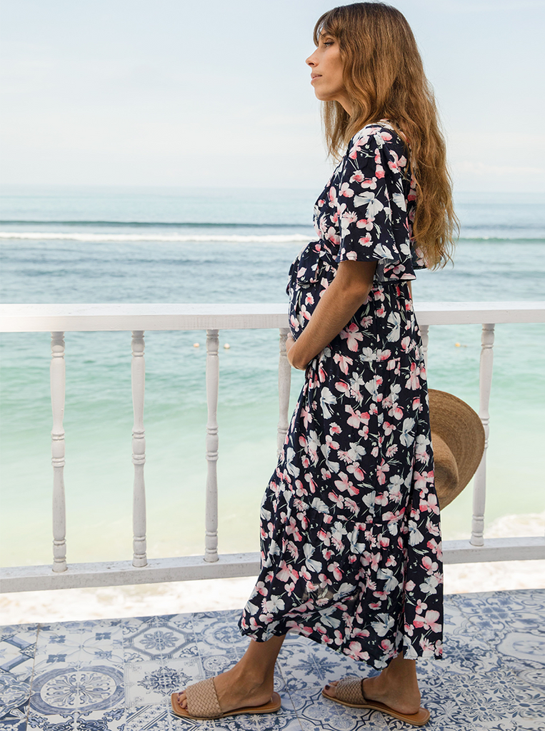 A woman in baby shower navy floral print maternity dress, side (6659011674206)