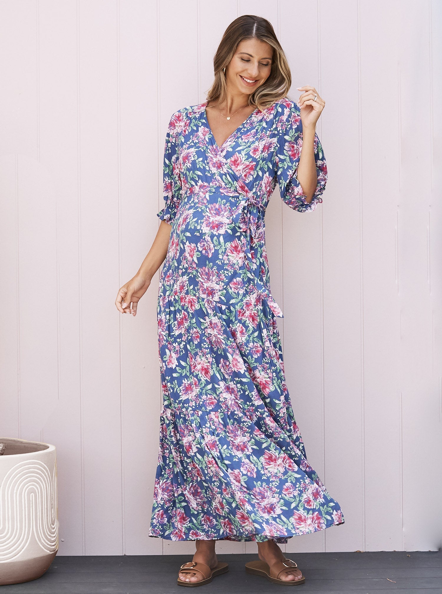 A Pregnant Woman in Elise Baby Shower Maternity Wrap Dress in Blue Flora from Angel Maternity