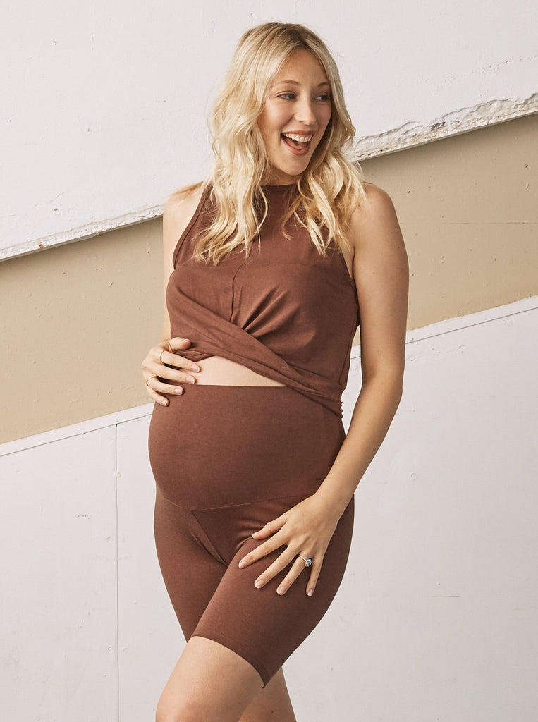 Main view - A pregnant Woman in Chocolate Brown Luxury Maternity Crop Top touching her bump & smiling (6707299909735)