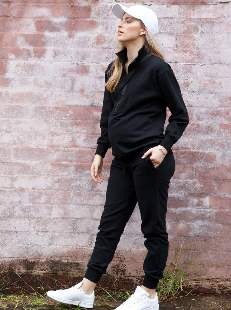 Main view - A pregnant woman in 2-Piece Calla zip front black Maternity Tracksuit Set (6718252810334)