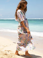 A woman in floral lavender maternity baby shower dress,  (6672554033246)