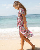 A woman in floral pink maternity & nursing wrap dress, side (6672544006238)