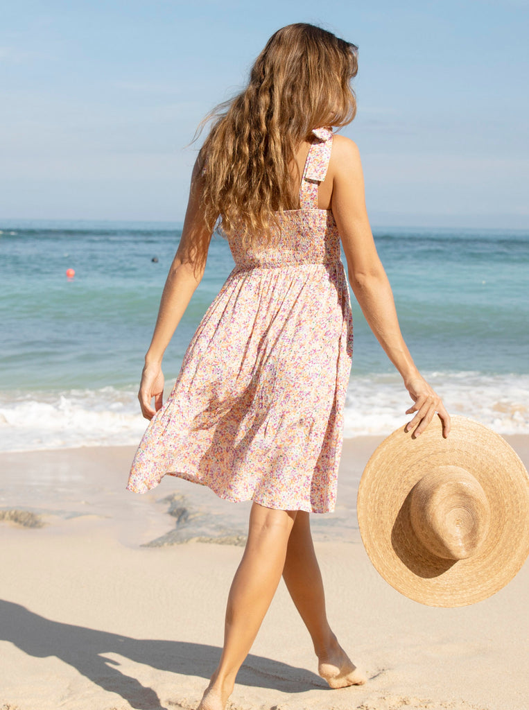 Back view - A pregnant woman in Shoulder Tie, Knee Length, Floral Print Maternity Sun Dress walking on the beach (6681440714846)
