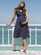A woman in linen maternity spot dress, main (6681442353246)