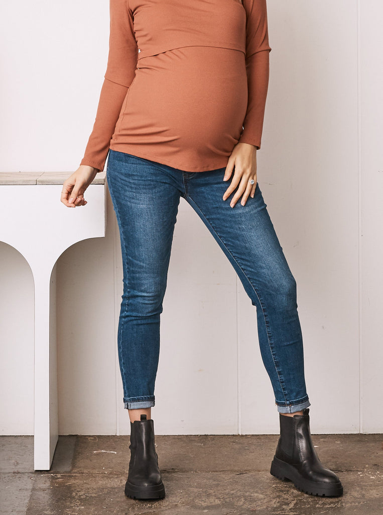 Main view - A Pregnant Woman in Maternity Over the Bump Fitted Denim Jeans in Indigo Color (6732693667934)